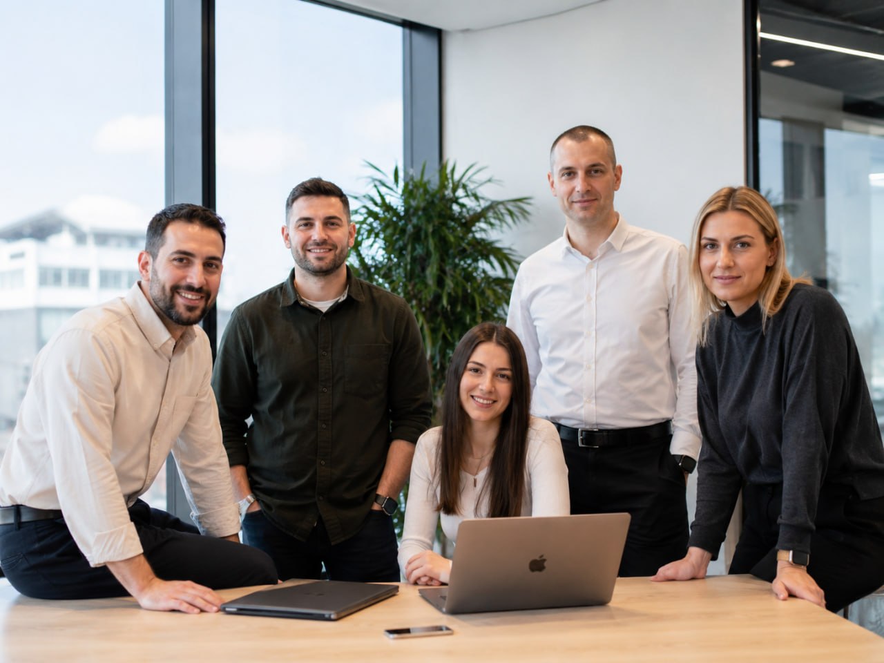 Synosonic team members gathered in a modern office
